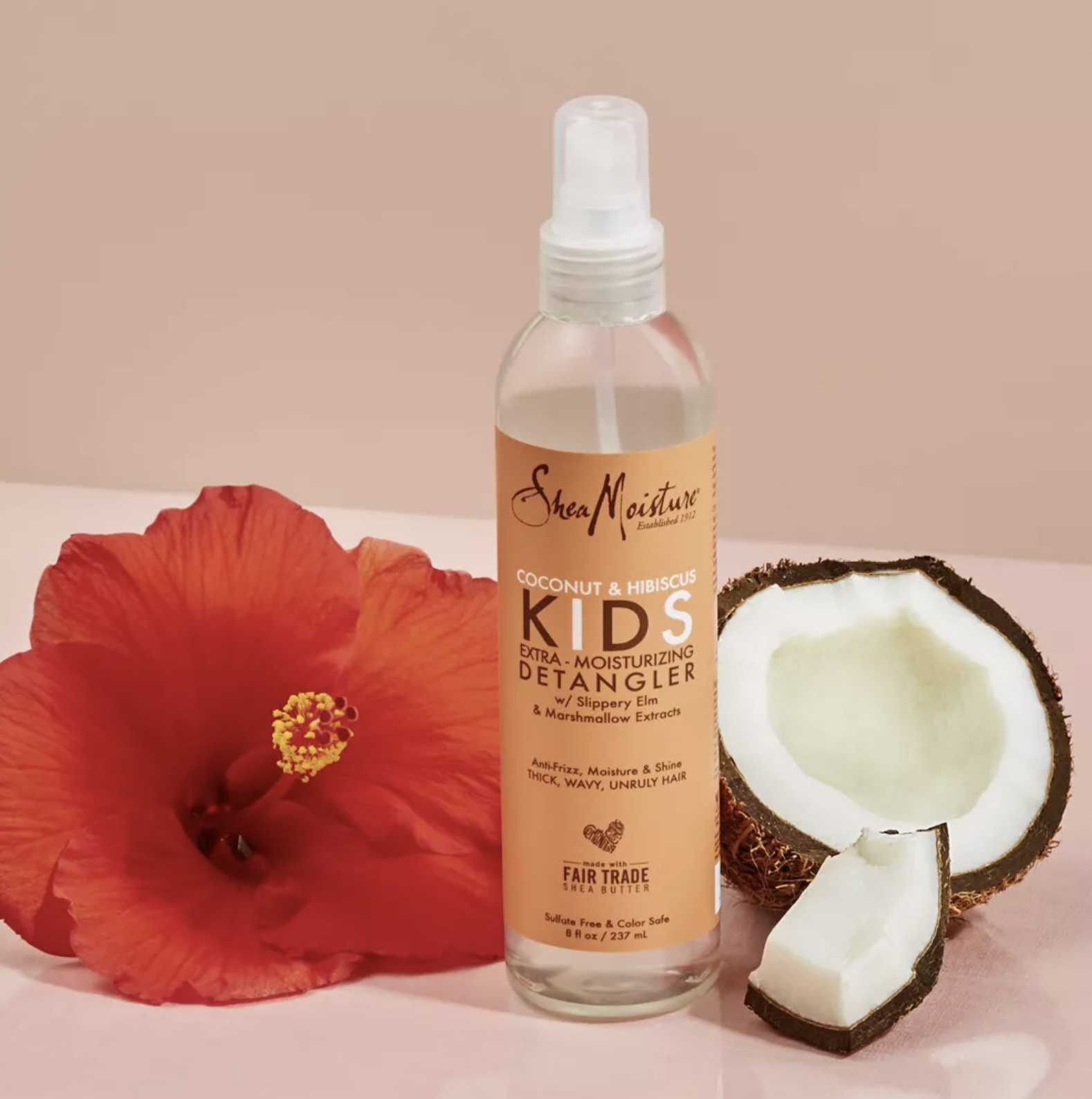 bottle beside coconut and flower