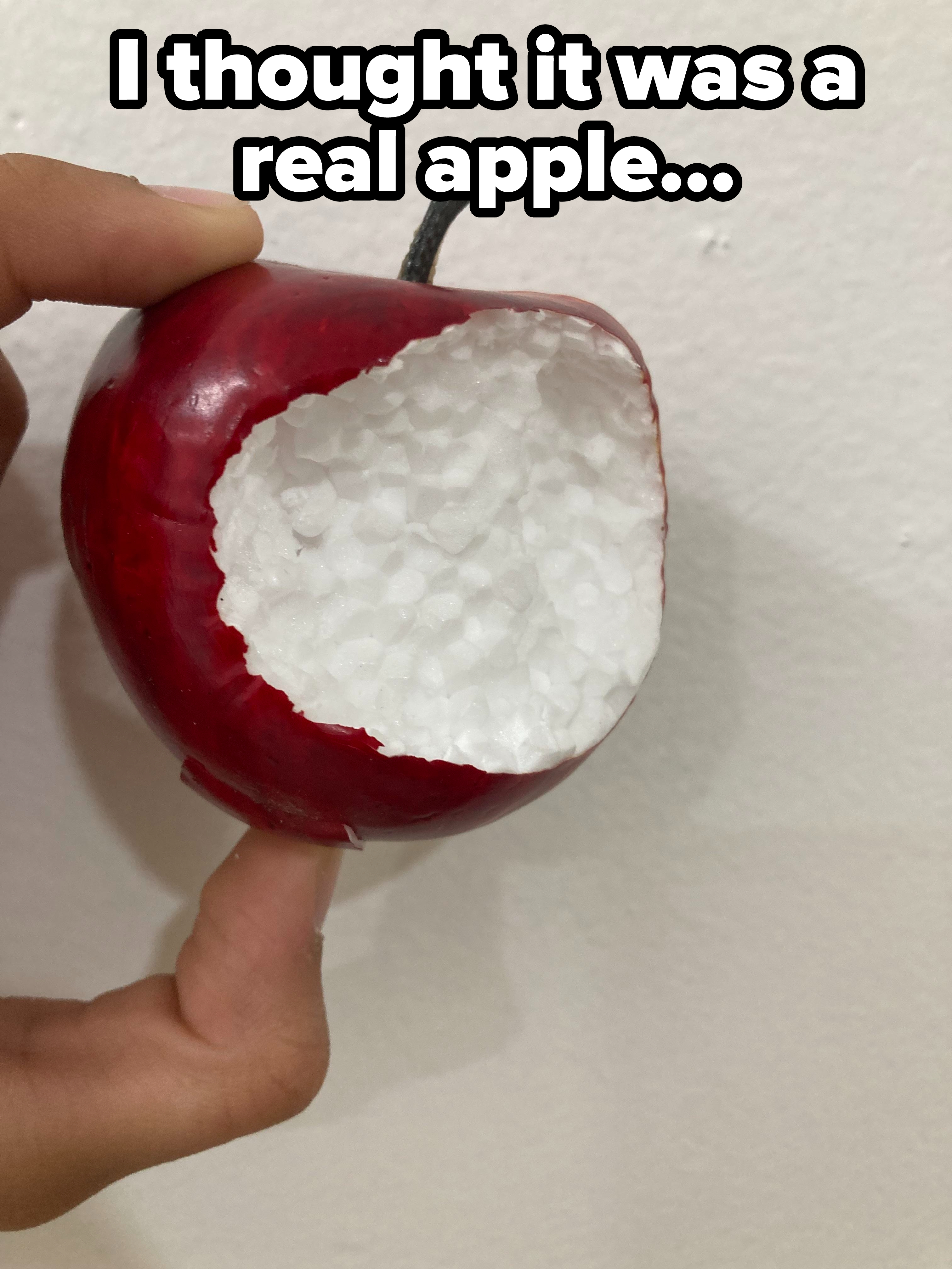 A fake apple with a bite taken out
