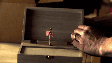 A person turning on a music box