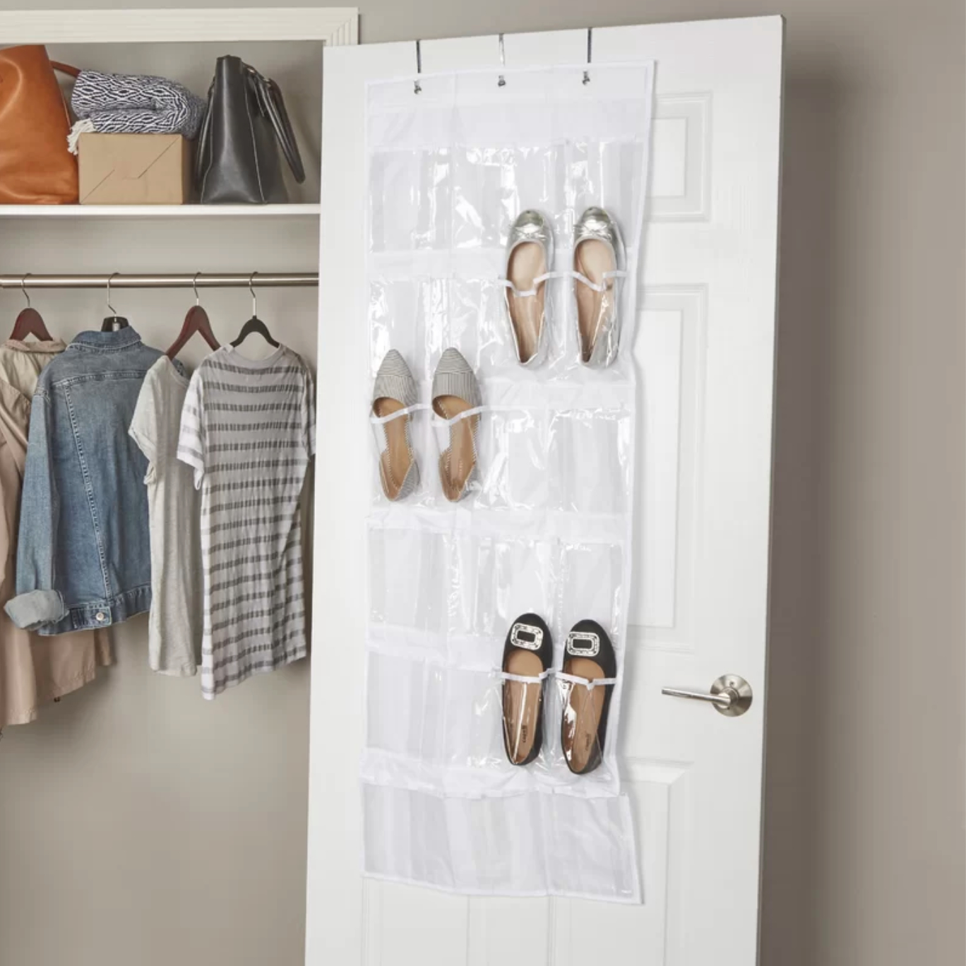a white hanging shoe organizer with three pairs of flats