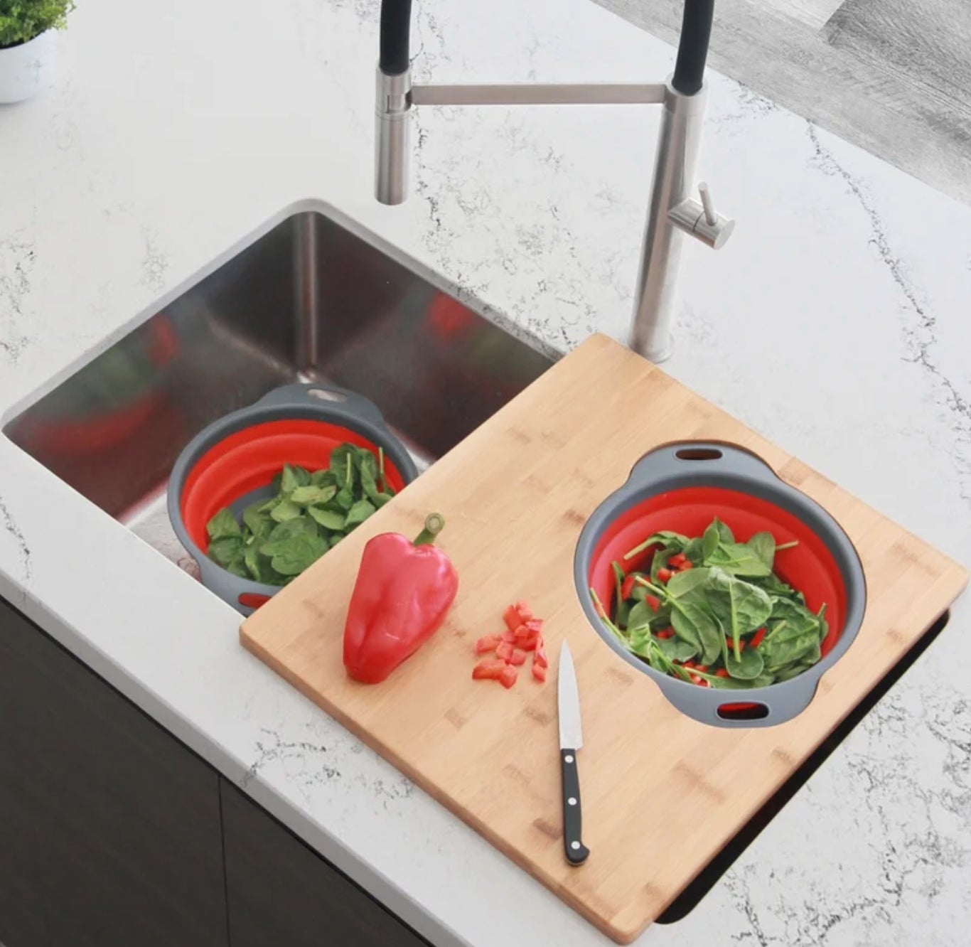 a bamboo cutting board that fits over a sink