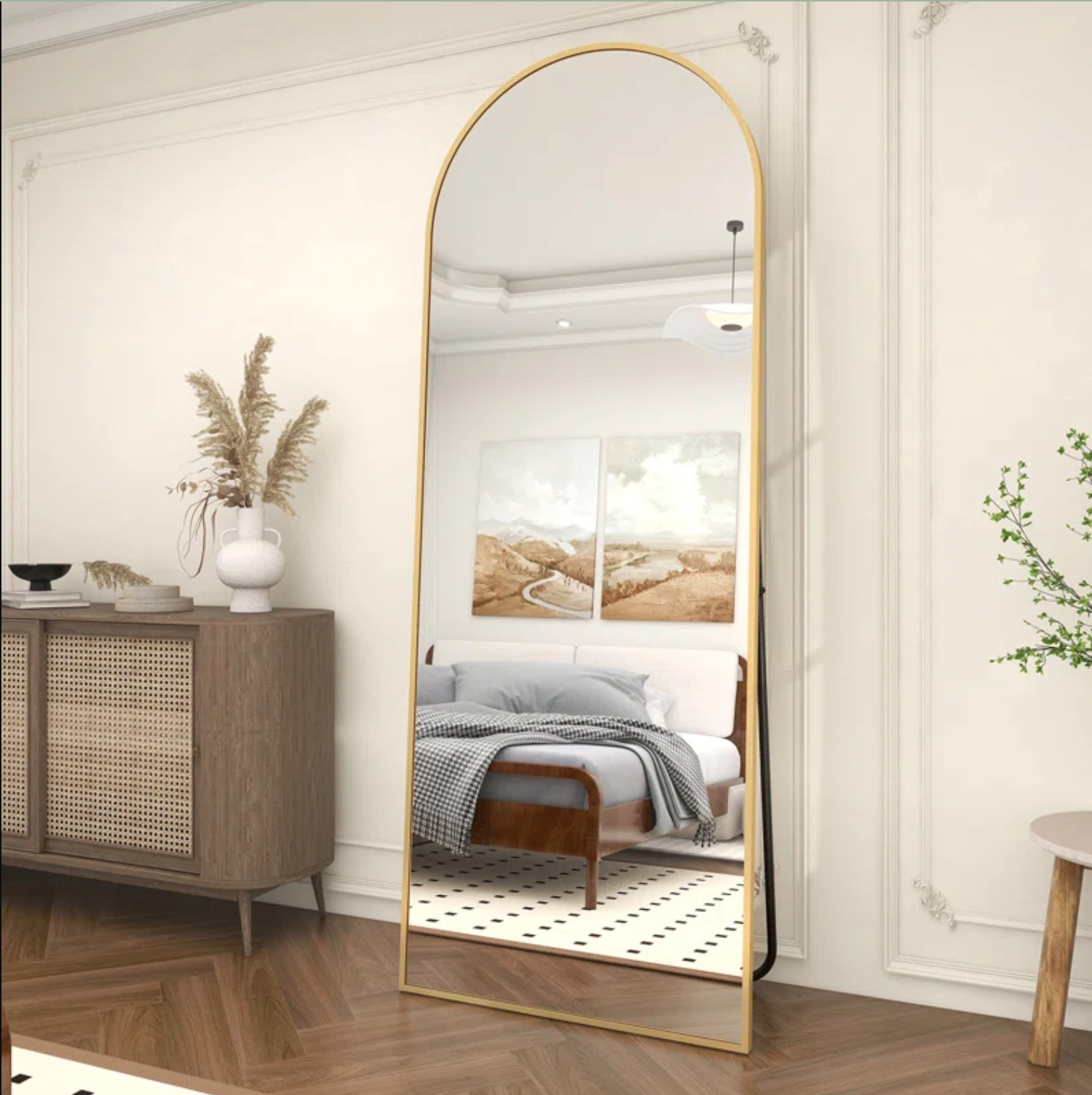 A arch-shaped mirror with a golden frame