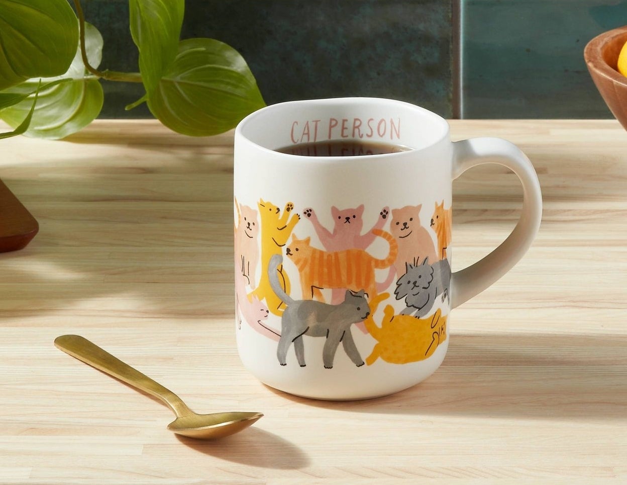 The white mug, featuring several kinds of cats in various colors