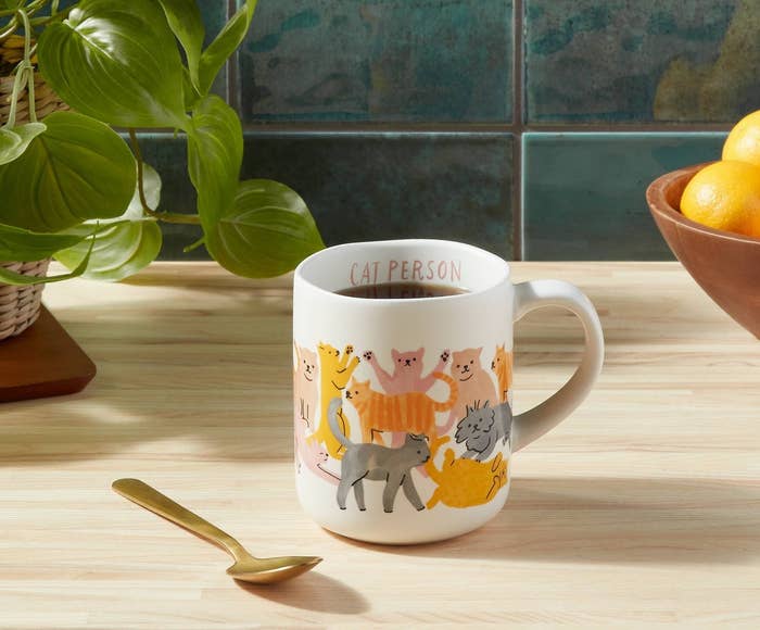 The white mug, featuring several kinds of cats in various colors