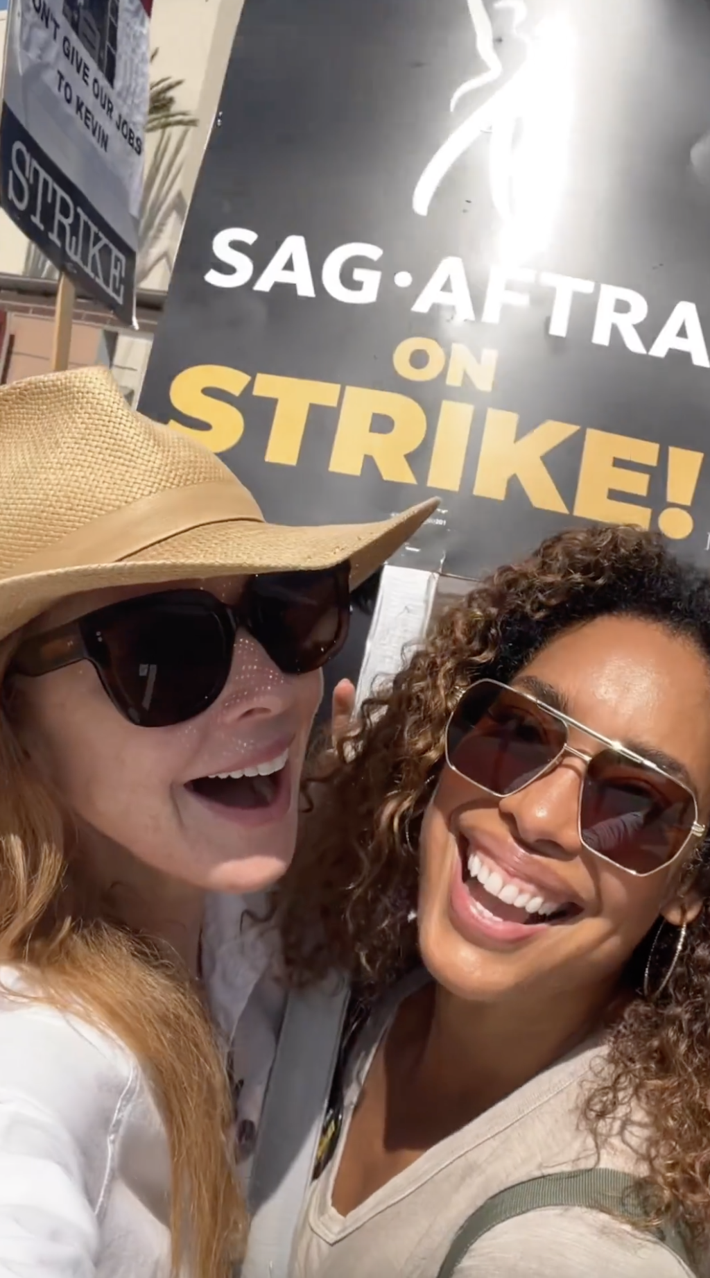 Closeup of Sarah Rafferty and Gina Torres at a WGA strike