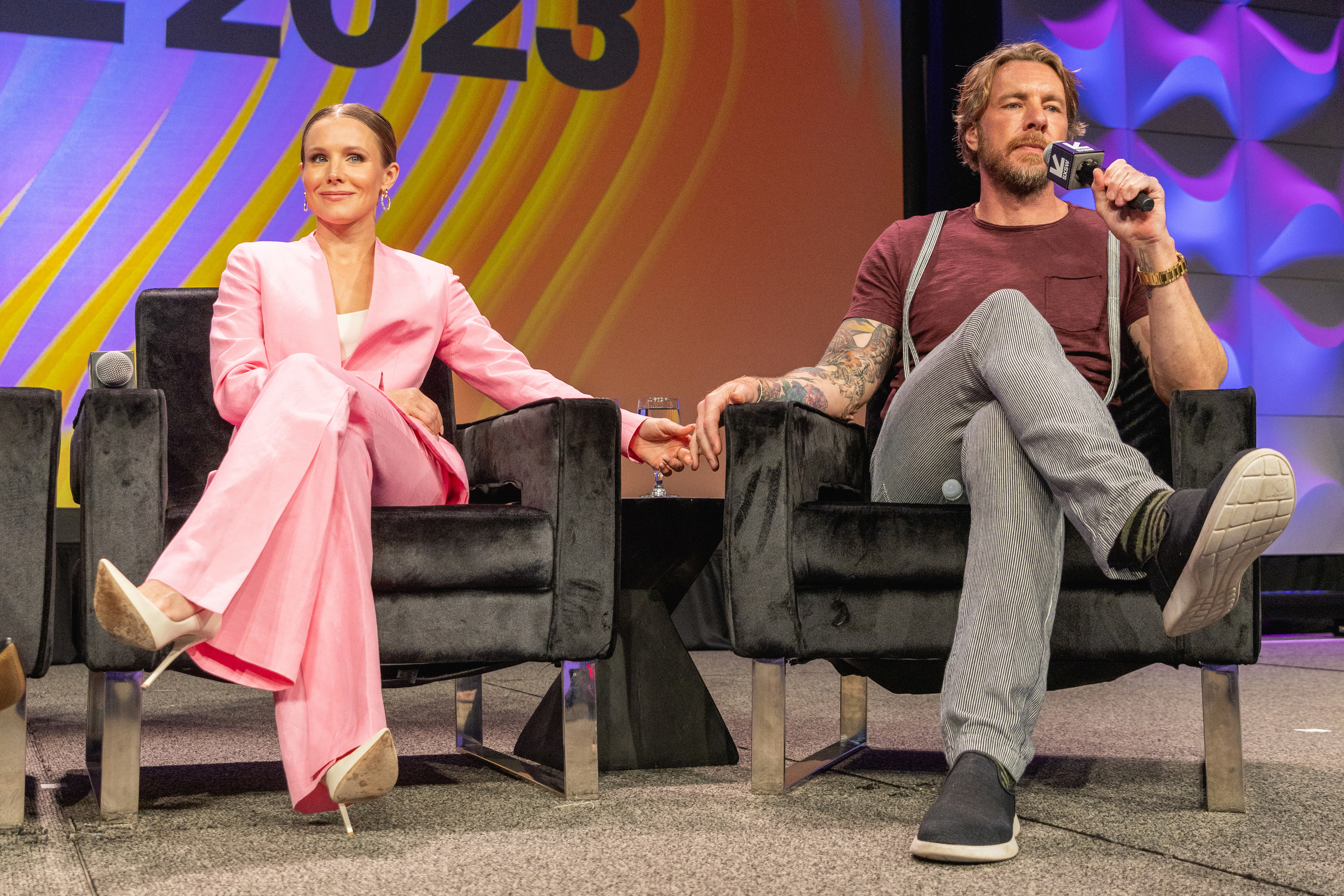 Kristen Bell and Dax Shepard sitting on stage during an interview