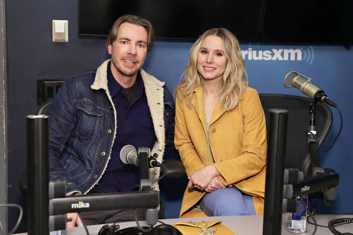 Dax Shepard and Kristen Bell smiling for a photo at a radio interview