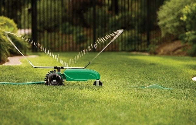 the rotating lawn sprinkler on a lawn