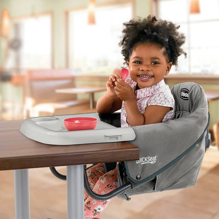 Baby eating in a booster seat