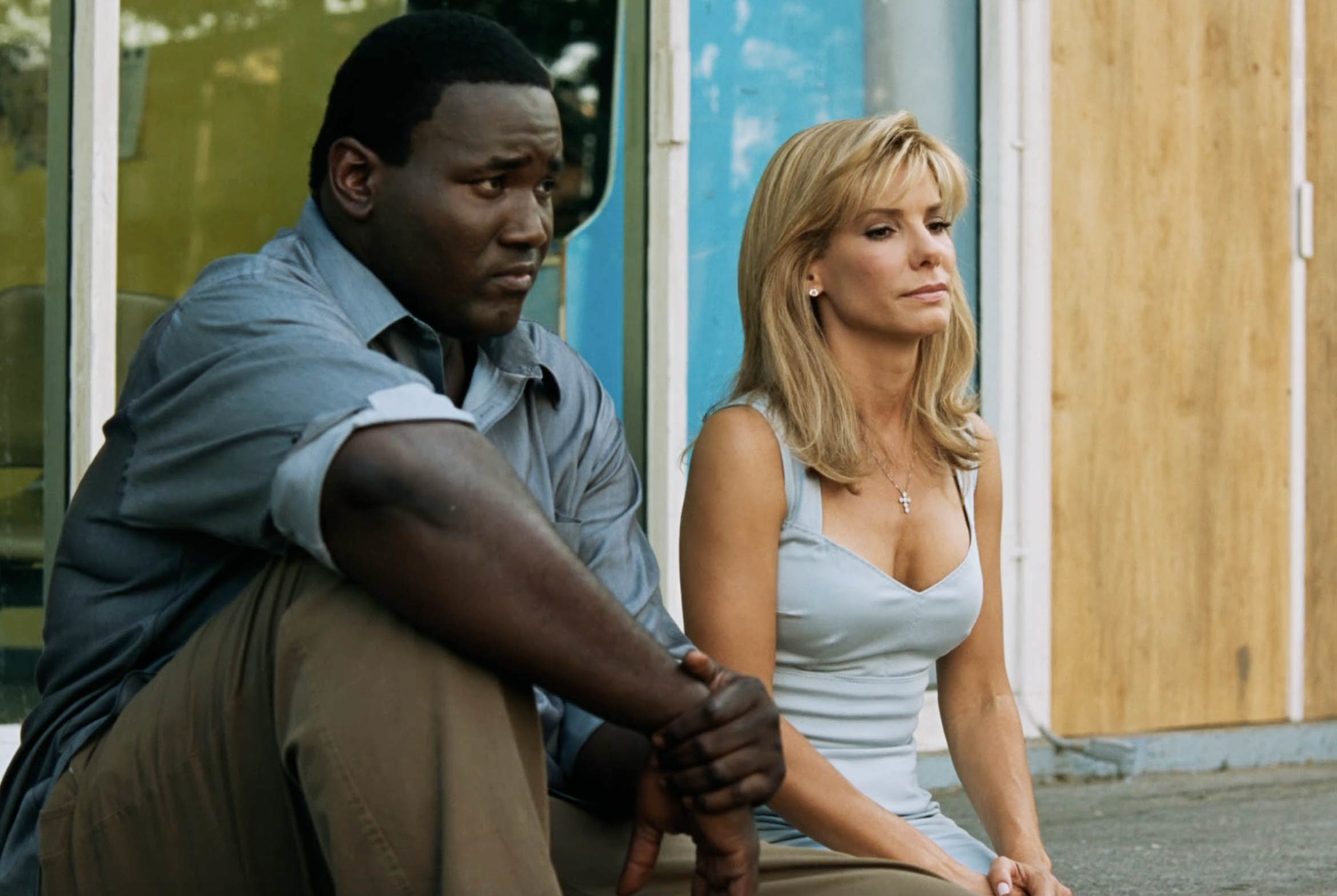 Michael and Leigh Anne Tuohy sitting next to each other in a scene from the film