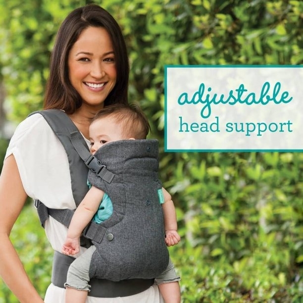 A parent using a baby carrier outside