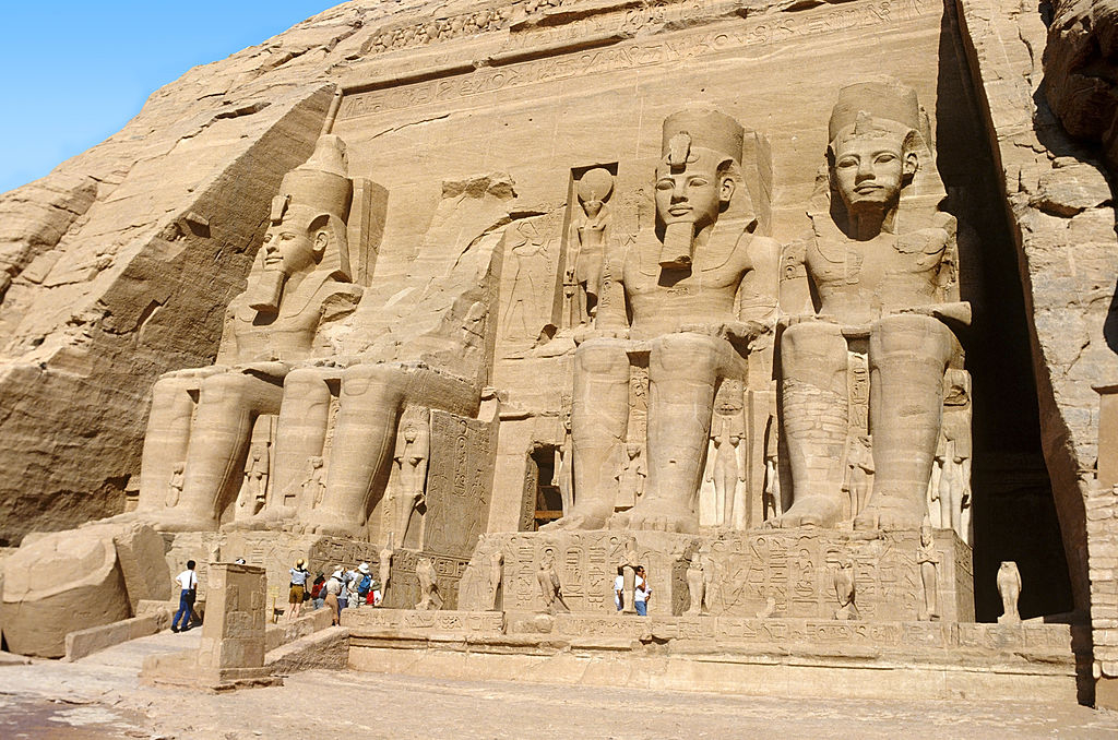 People at the entrance to the temple, with several of these statues soaring above them