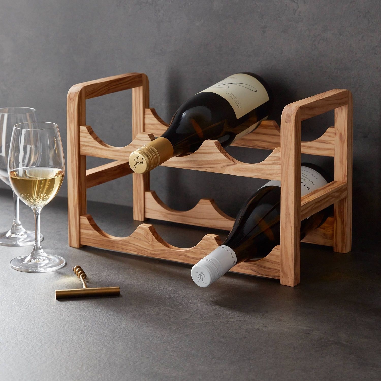 Two-tiered wine rack with two bottles on it