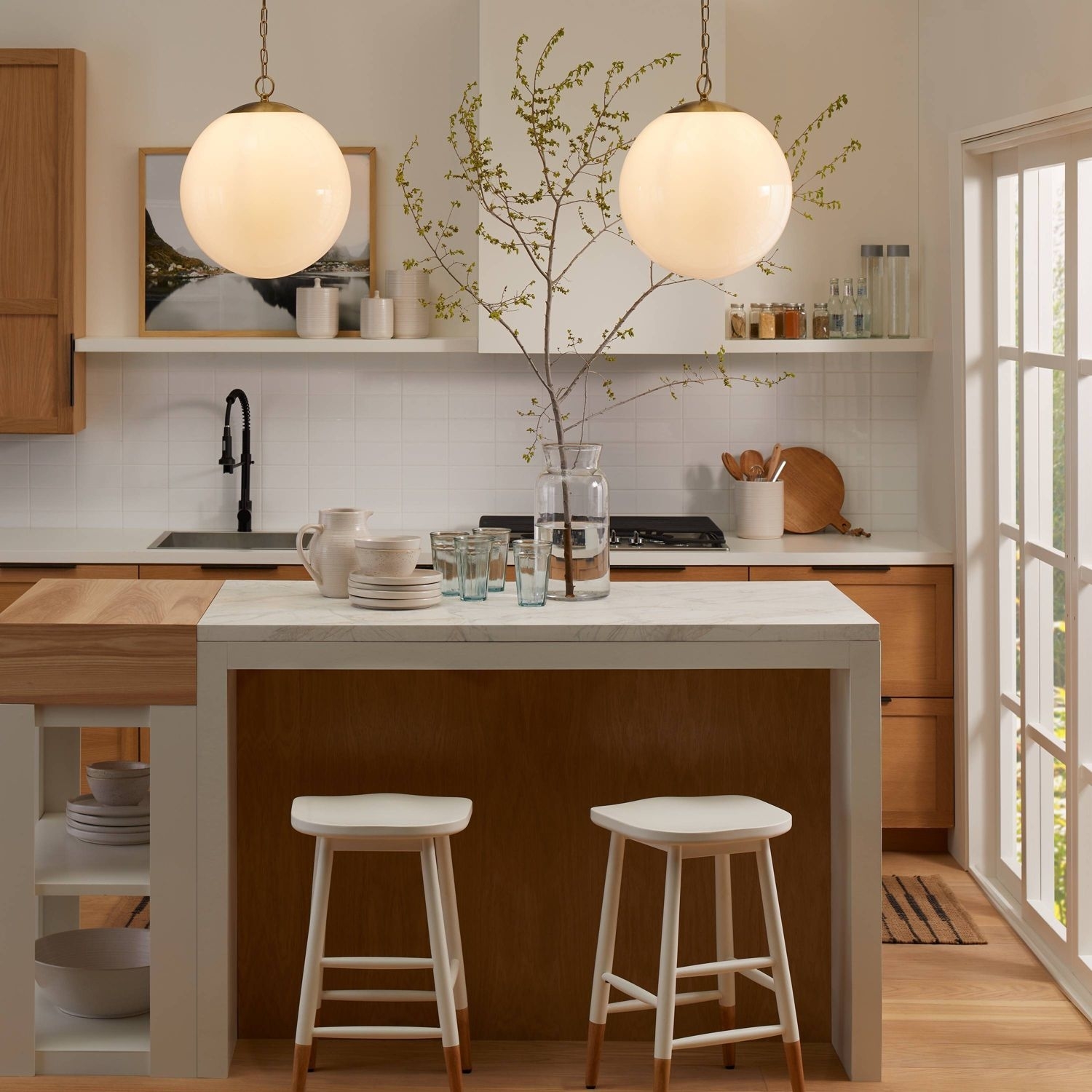 A pair of the pendants hanging above a kitchen island