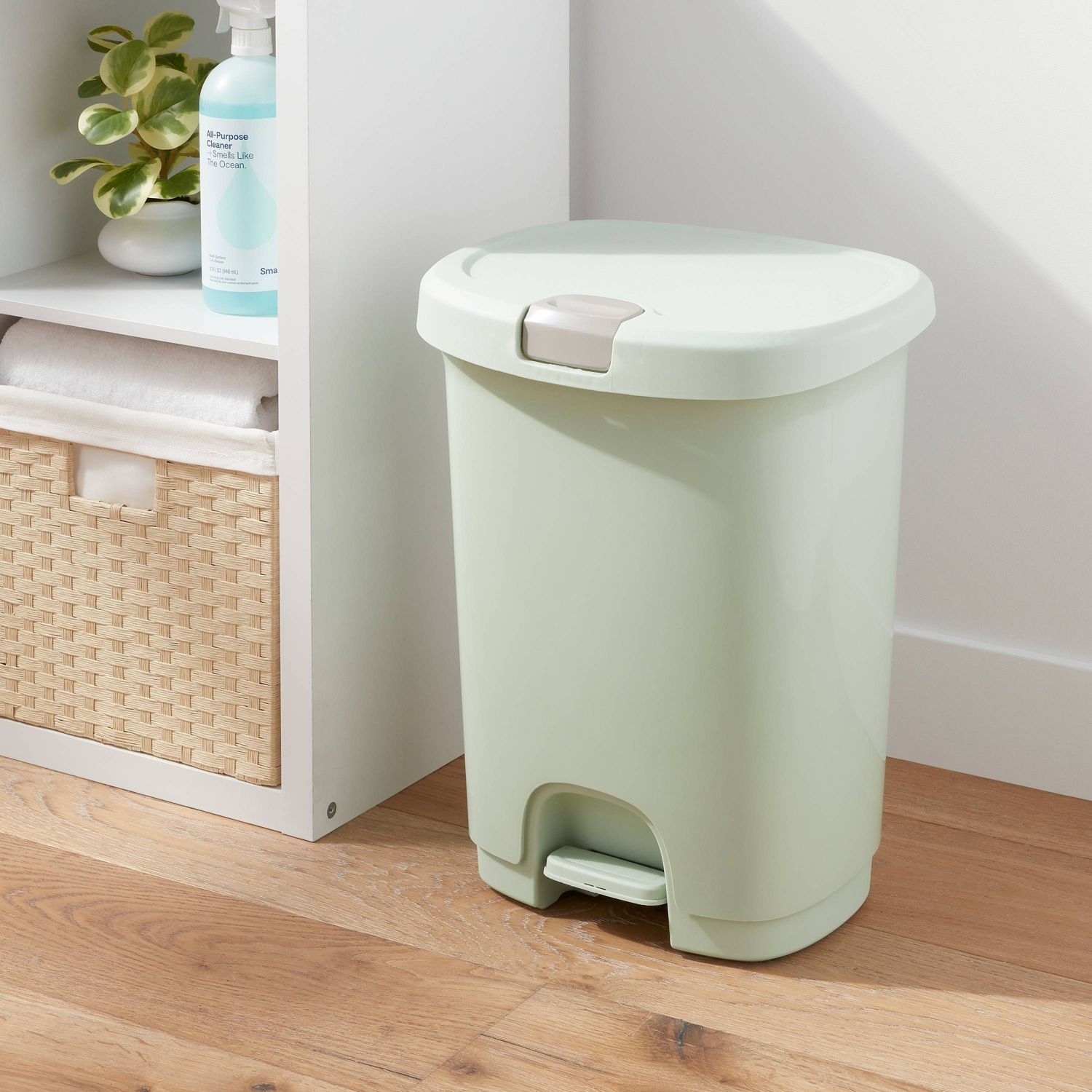 The trash can, featuring a touch button on the lide and a step pedal