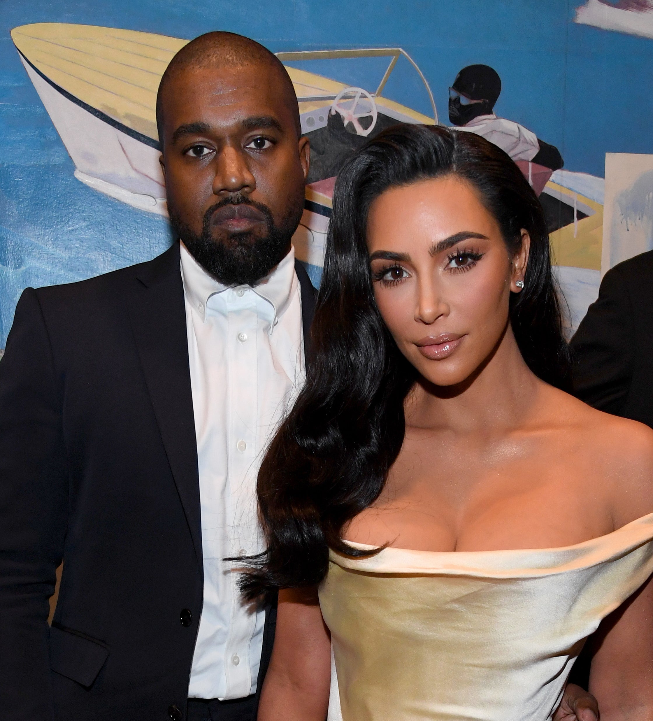 A closeup of Kanye and Kim standing for a photo at a media event