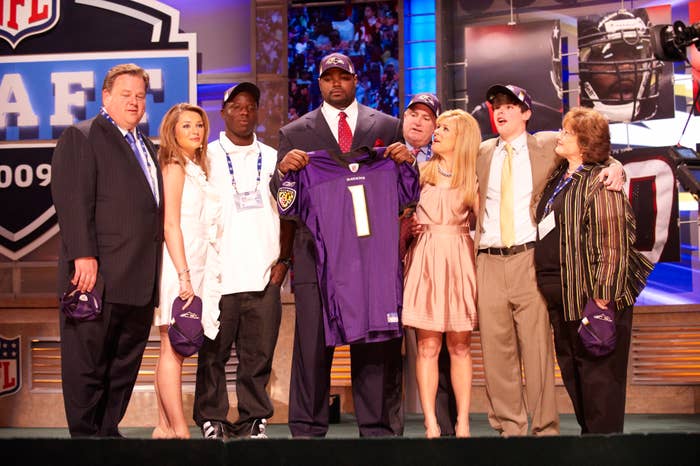 Michael Oher on stage at the NFL draft with the Tuohy family