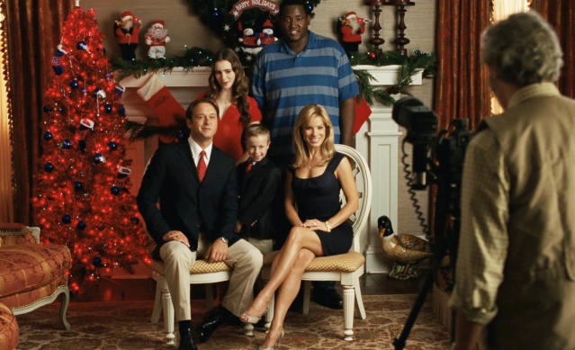 The Touhy family and Michael taking a Christmas photo in a scene from &quot;The Blind Side&quot;