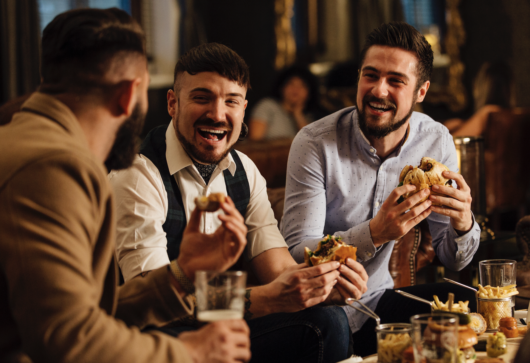 group of men eating at a bar