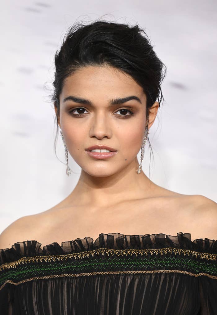 A closeup of Rachel Ziegler in an off the shoulder ruffled outfit on the red carpet