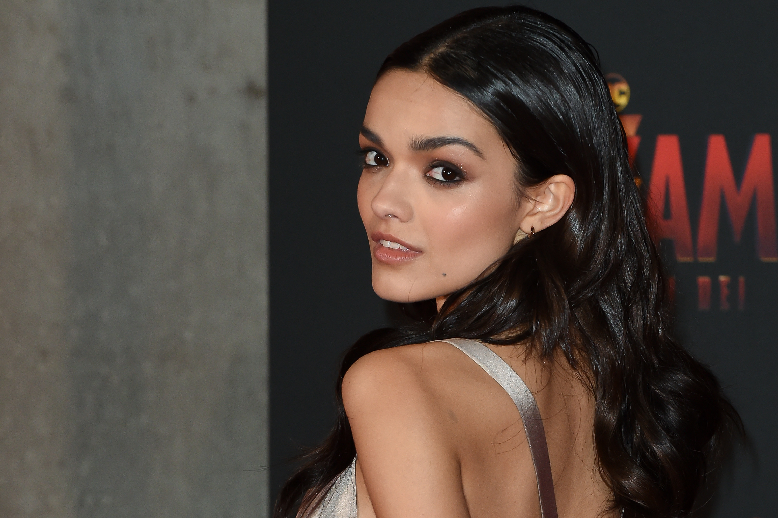 Rachel looking over her shoulder as she poses for photographers at an event