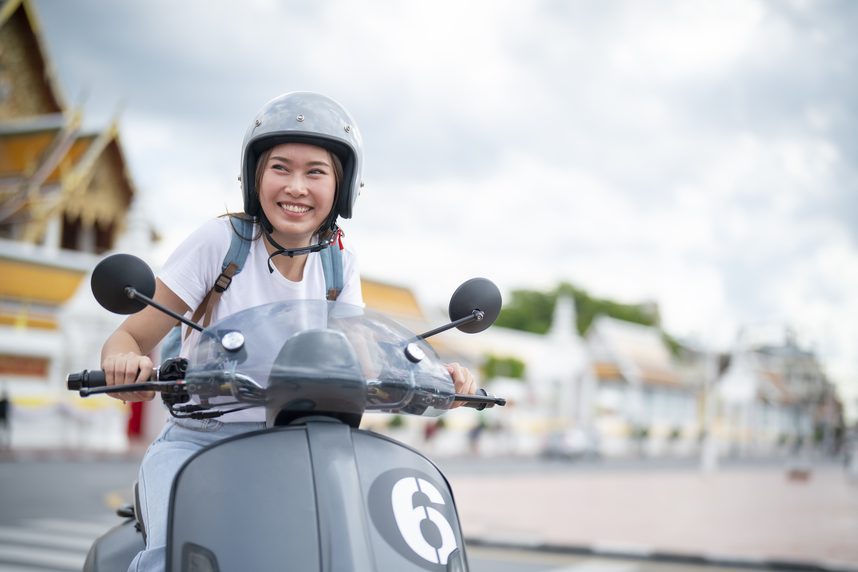 A woman riding a motor scooter
