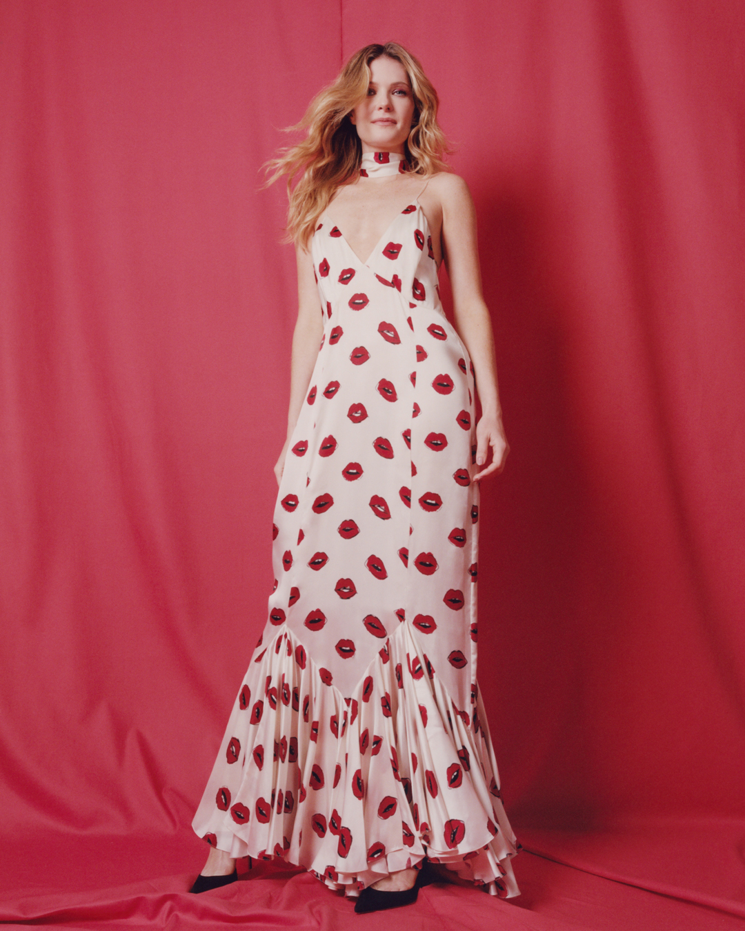 Meghann Fahy wearing a long dress with a kissing lips pattern for an editorial shoot