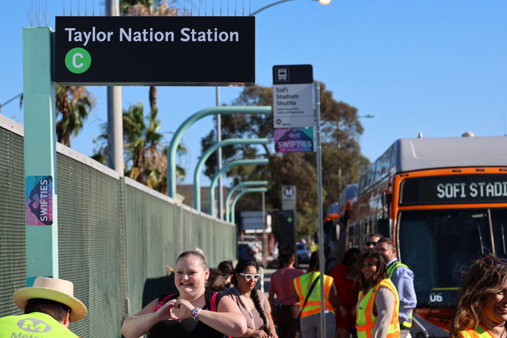 Swifties arrive to take a free shuttle bus from the temporarily renamed &quot;Taylor Nation Station&quot; Metro C Line Station to SoFi stadium