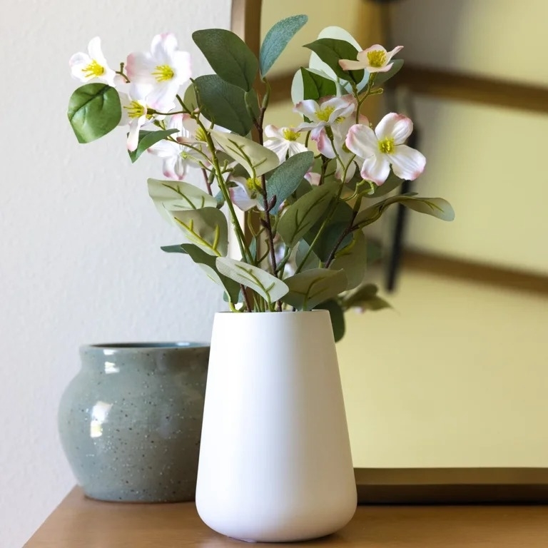 white vase filled with white flowers