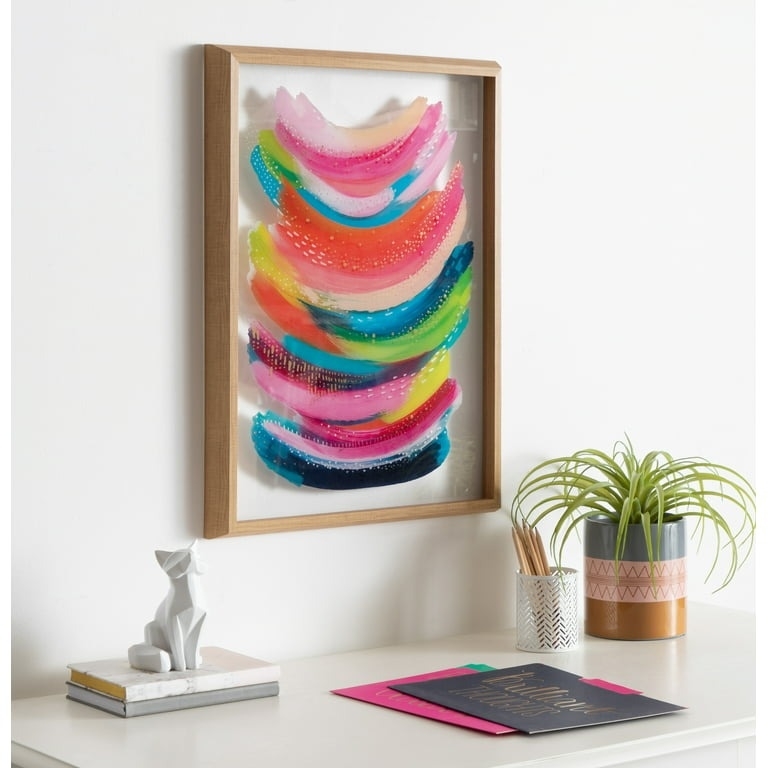 colorful abstract painting in a glass frame on wall