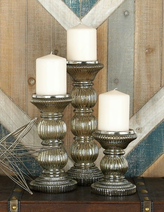 three handmade pillar candles on brown table