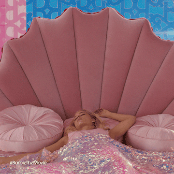 Barbie waking up in her glitter bed with a start