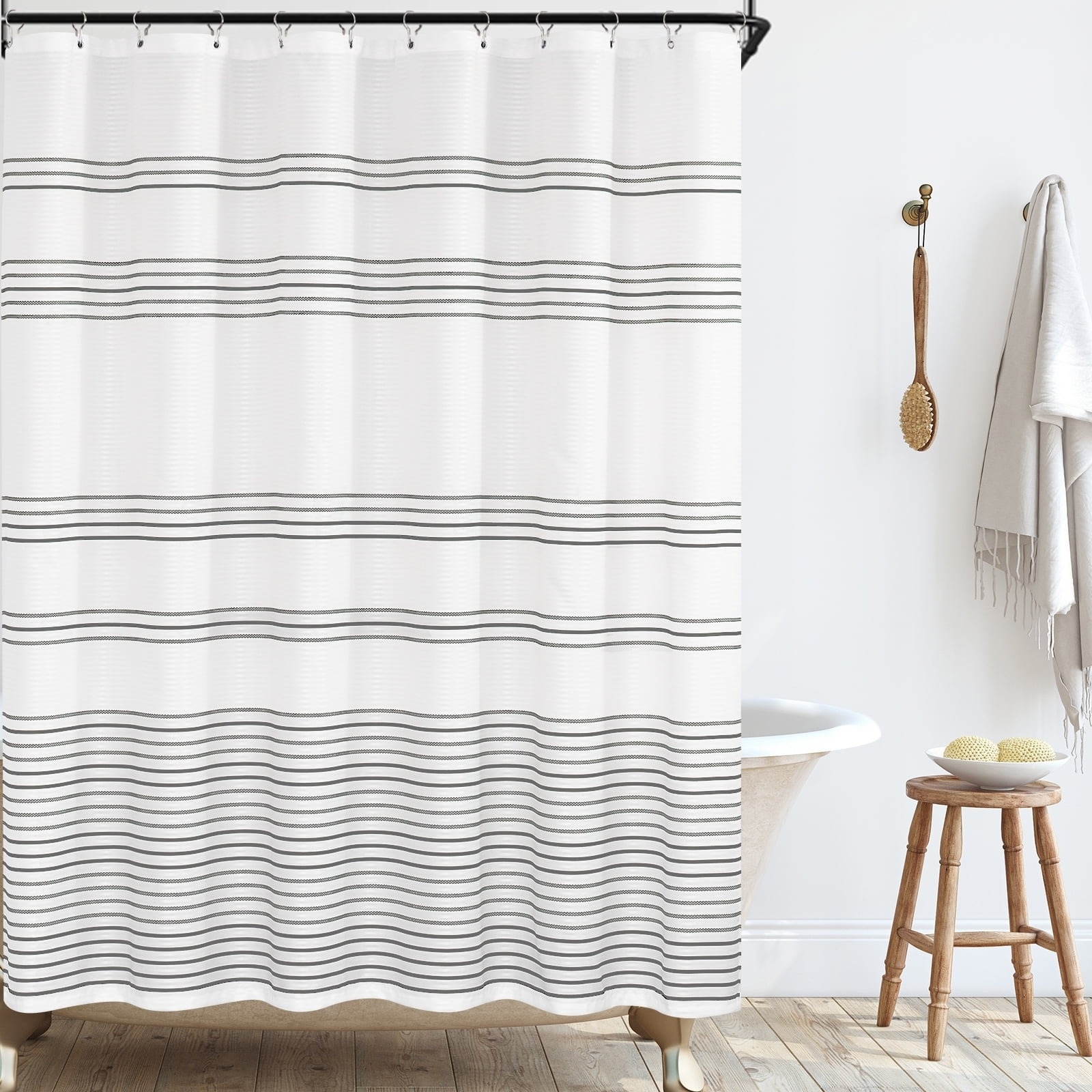 a striped shower curtain hung over a tub