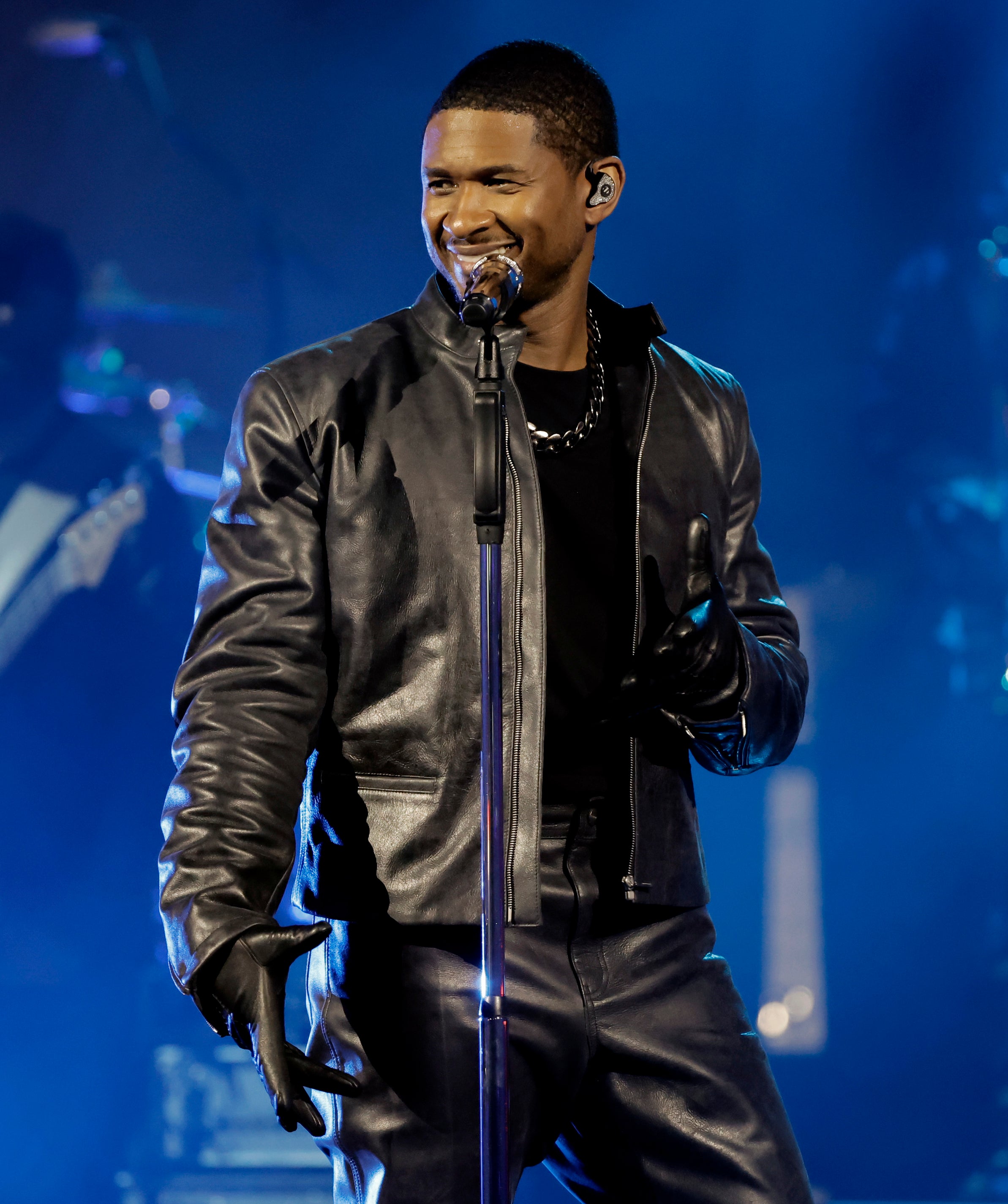 Usher smiles as he performs on stage