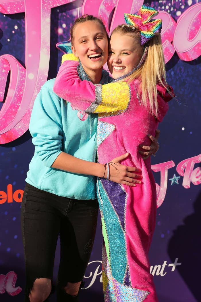 Close-up of JoJo smiling and embracing then-girlfriend Kylie Prew at a media event
