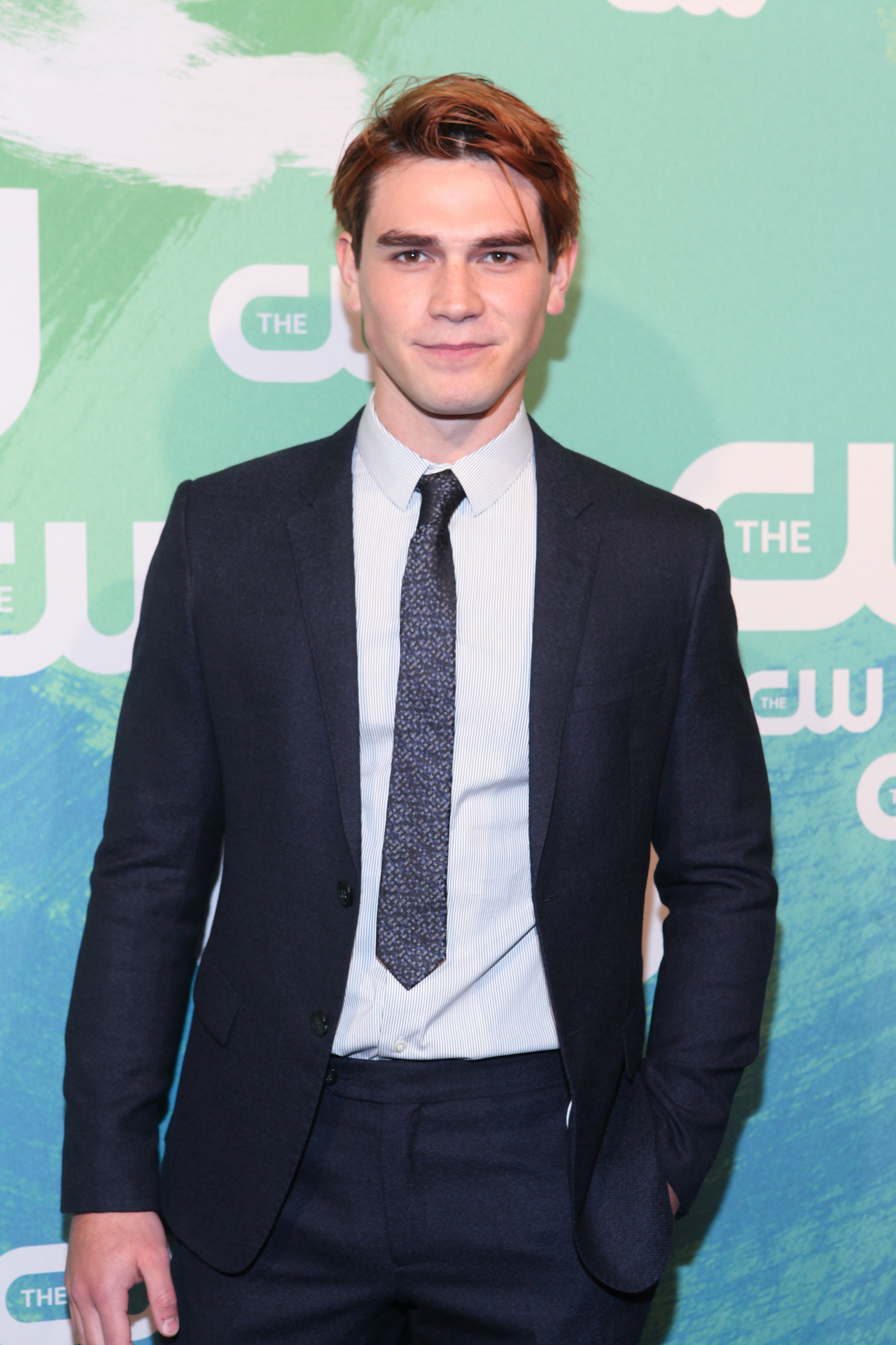 Closeup of KJ Apa on the red carpet in a suit and tie