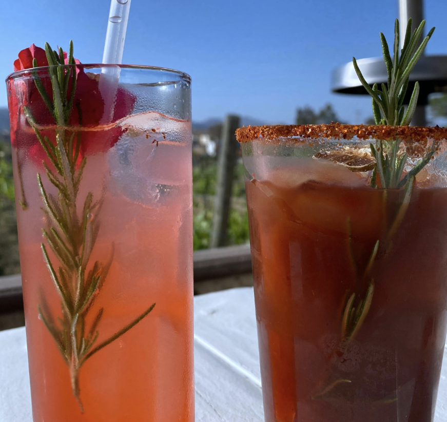 On the left is an agua fresca, on the right sits a glass of michelada