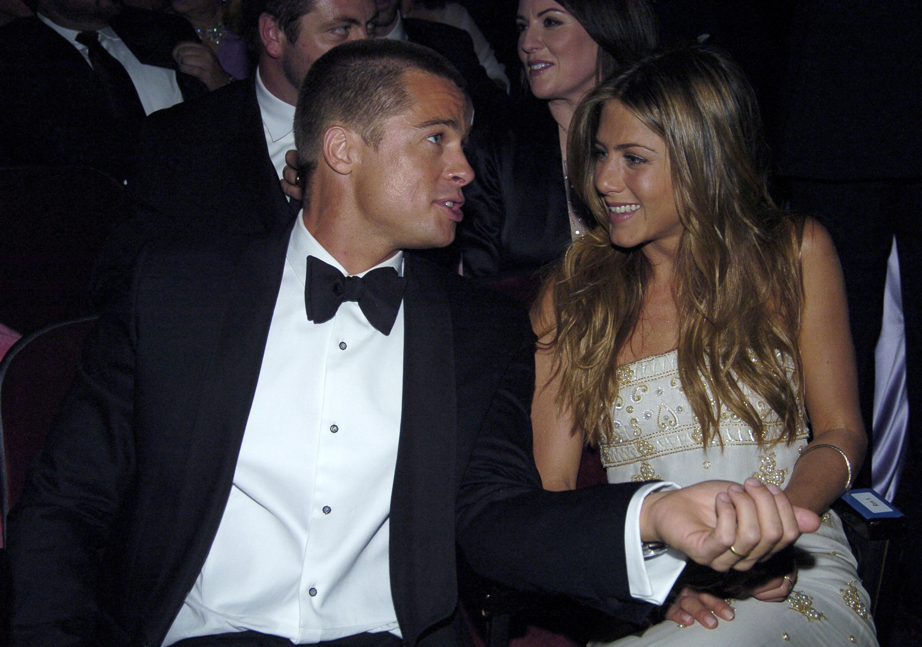 Close-up of Brad in a bow tie and Jen sitting together