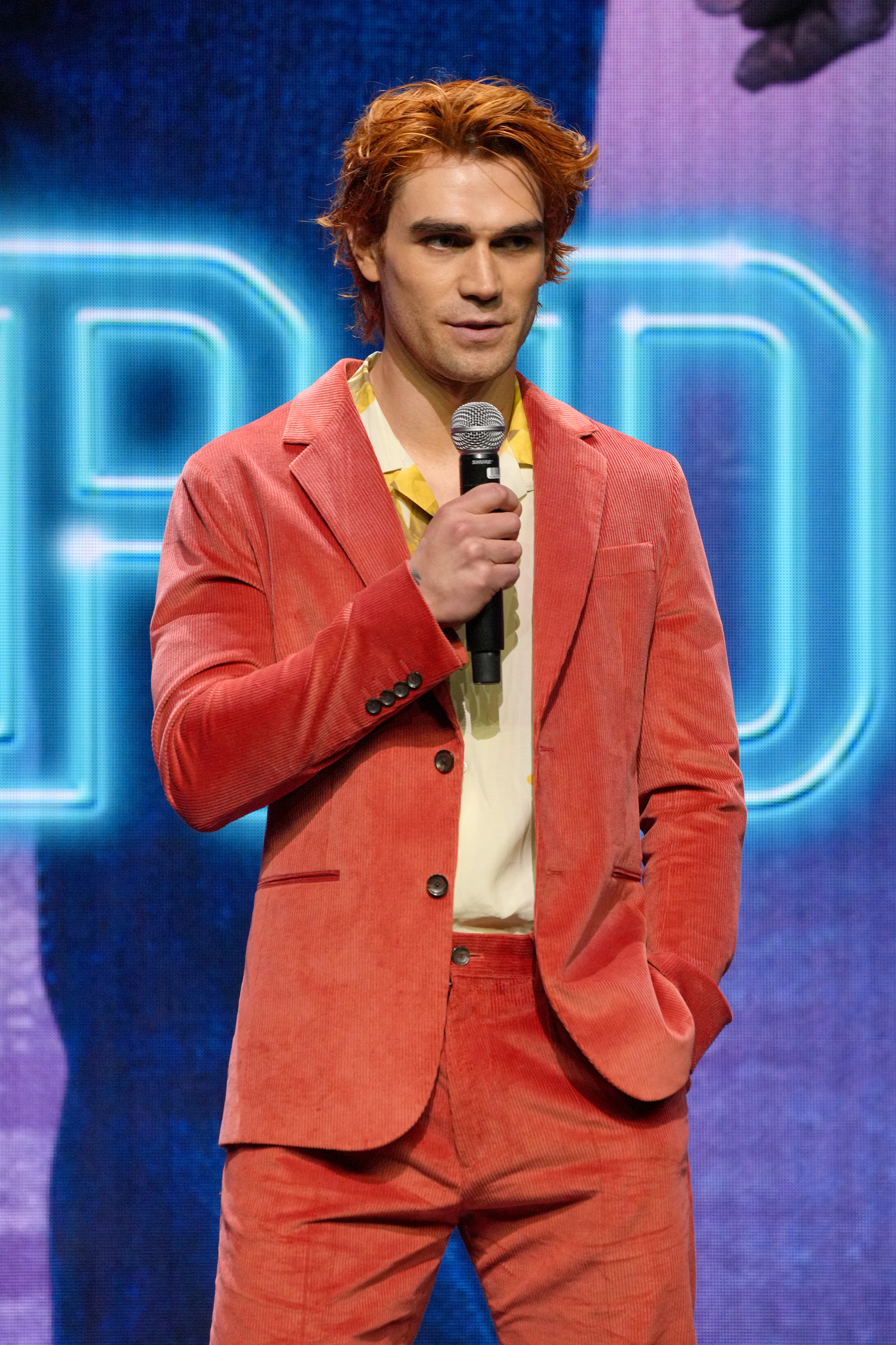 KJ Apa speaking into a microphone