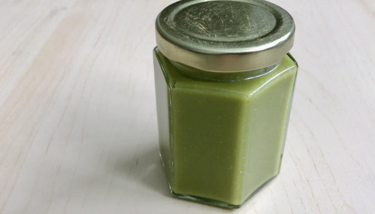A jar of pandan juice sits on a table