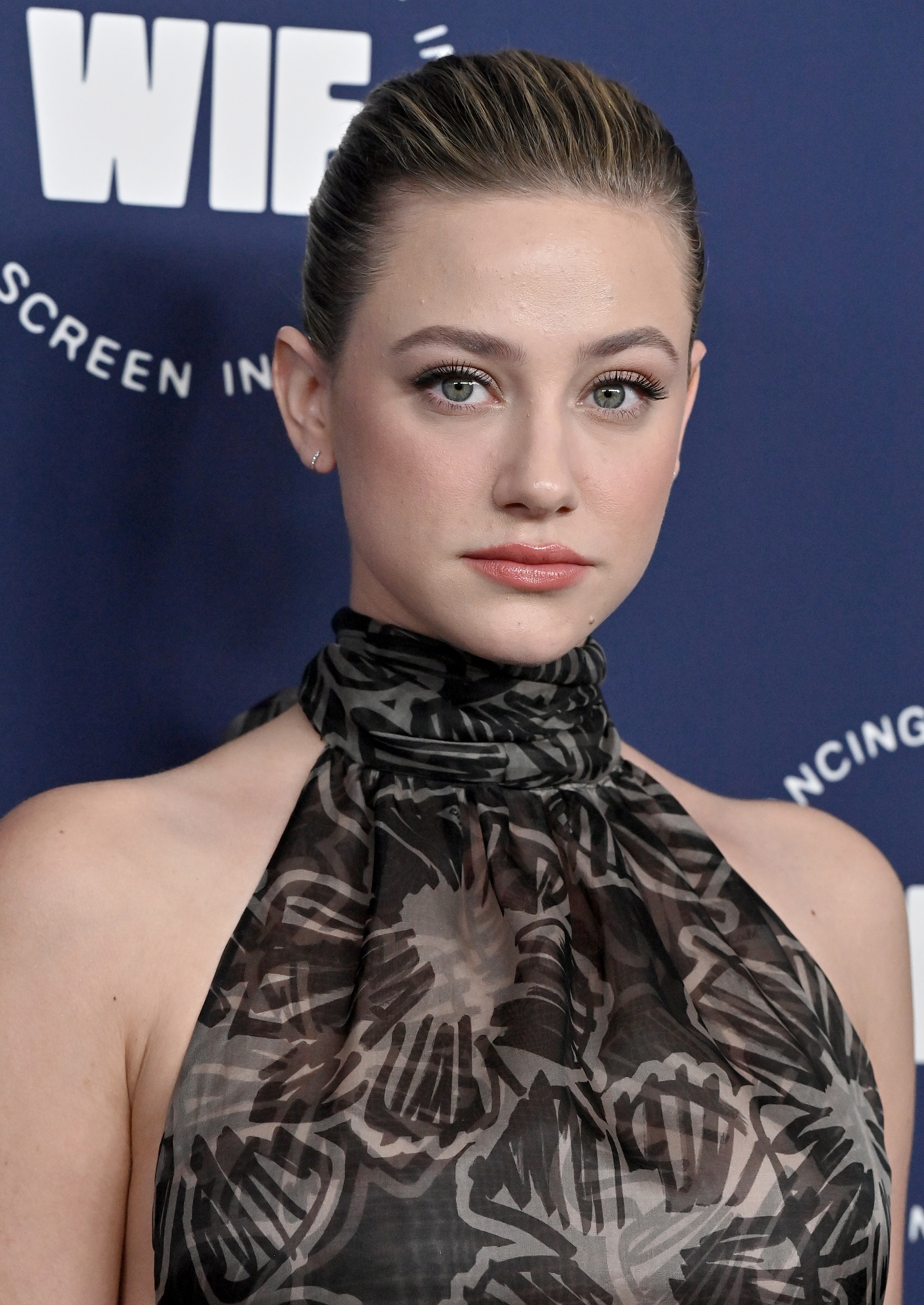 Close-up of Lili at a media event in a halter top