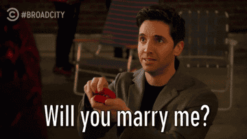 someone on their knee saying, will you marry me