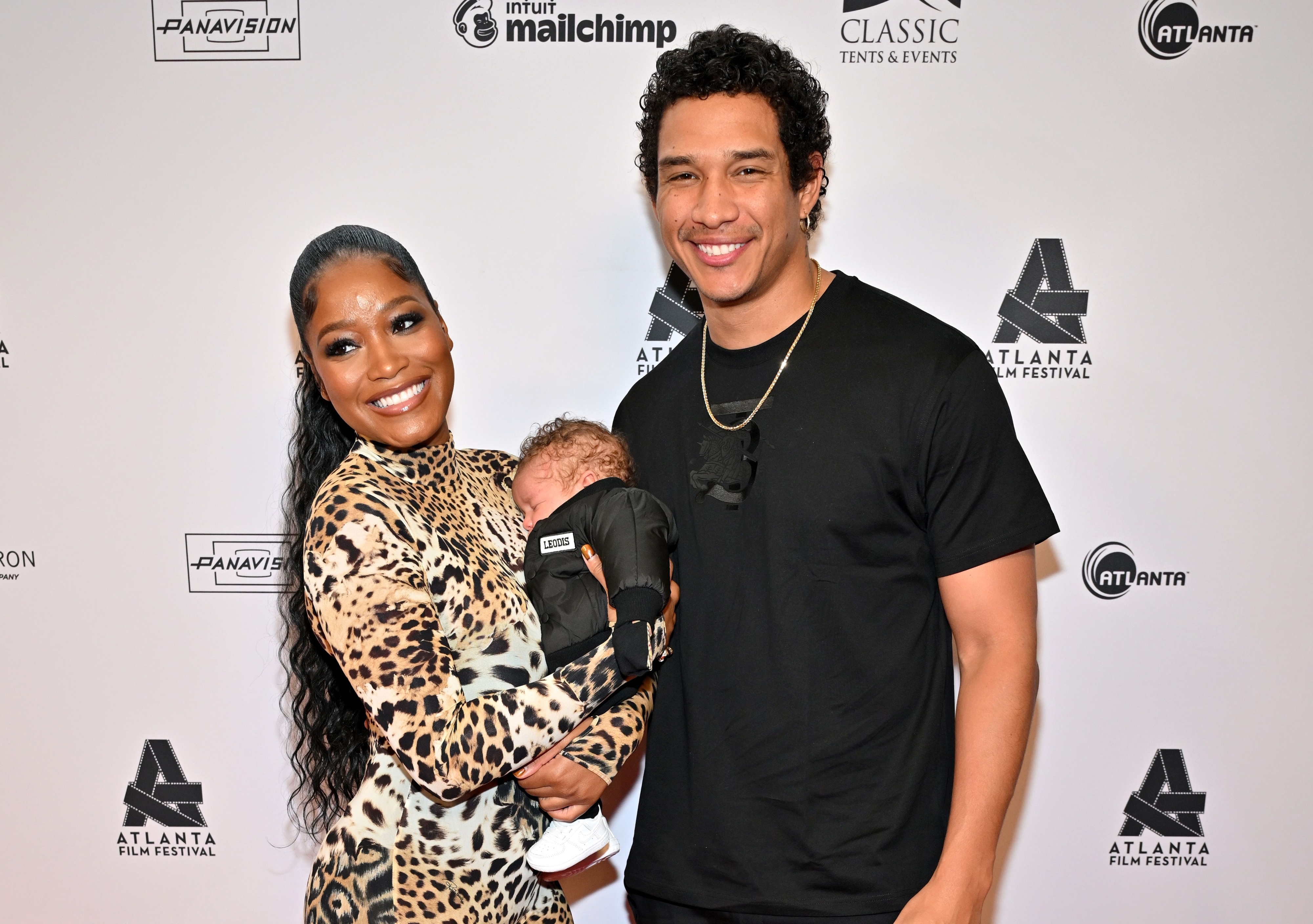 Closeup of Keke Palmer and Darius Jackson with their baby at a media event