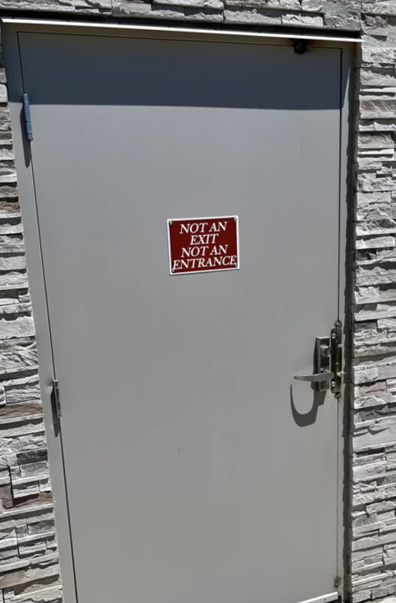 door sign reading not an entrance not an exit