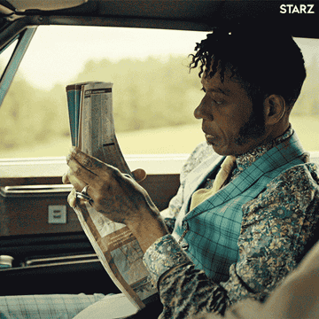 Orlando Jones as Mr. Nancy from the show &quot;American Gods&quot; is looking over a road map in a car