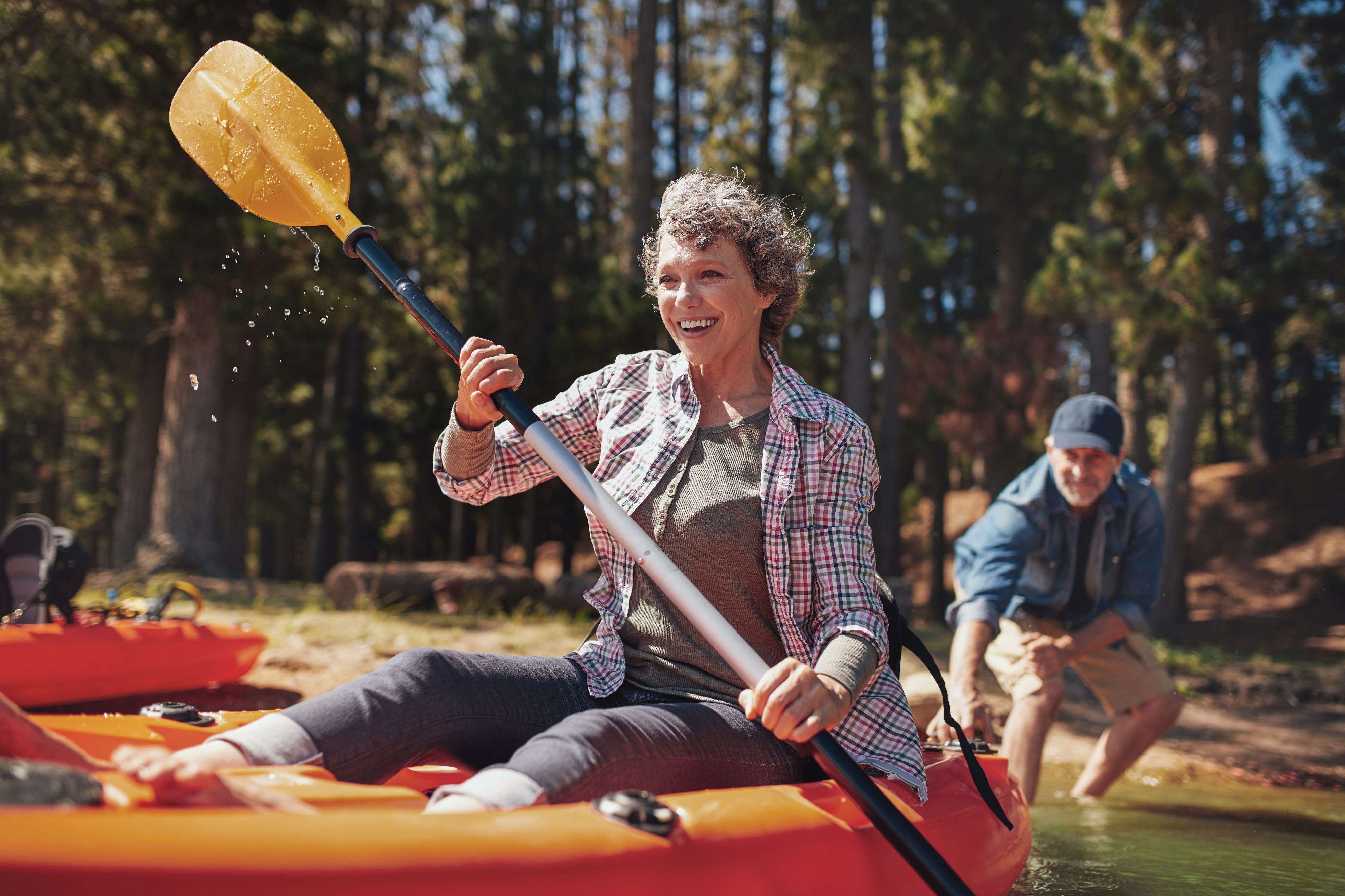 older woman paddling a kayak