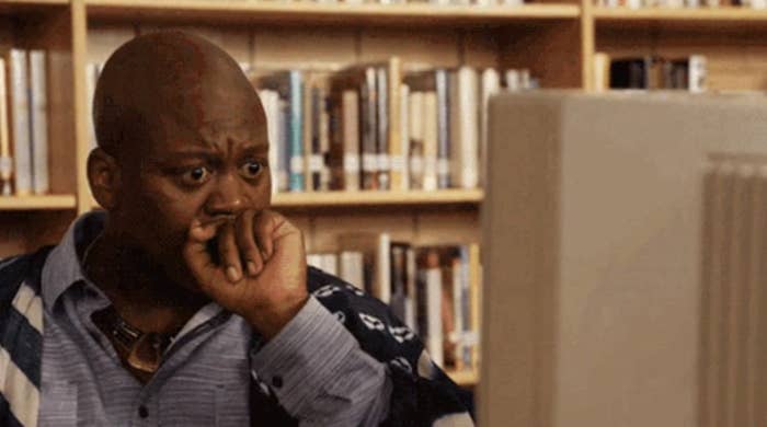 A man looking shocked in front of his computer