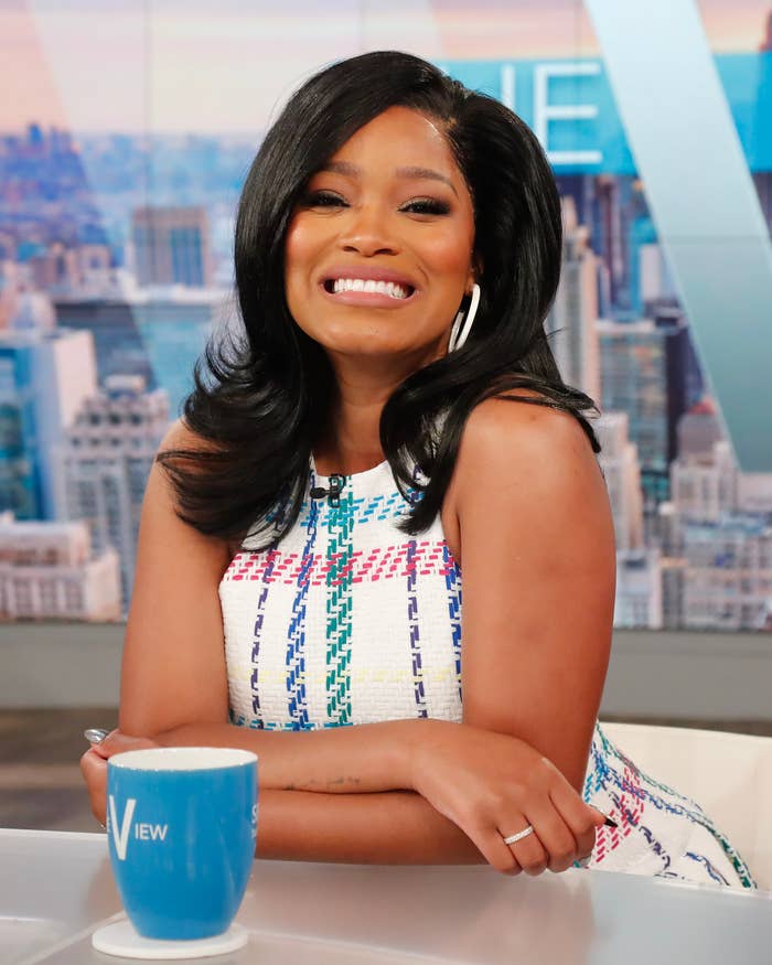 A closeup of Keke smiling as she sits on set of the talk show The View