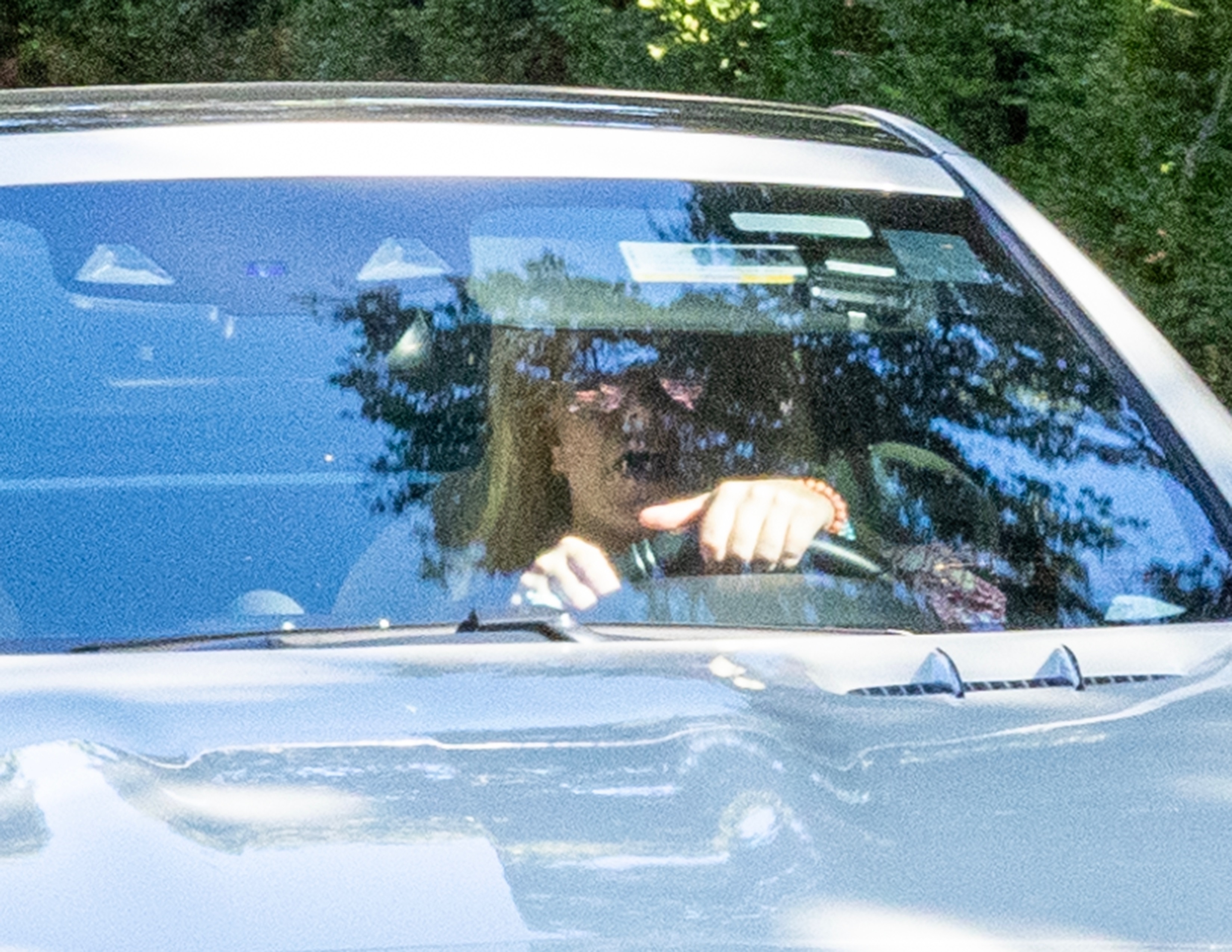 Close-up of Britney driving, with her hands visible