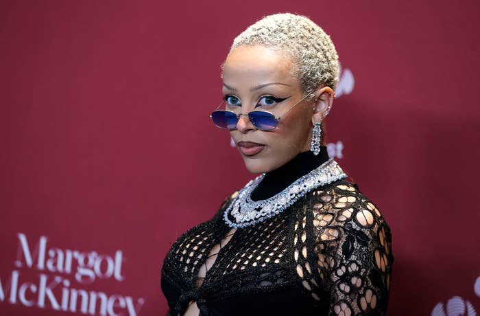 A close-up of Doja Cat wearing sunglasses on the red carpet